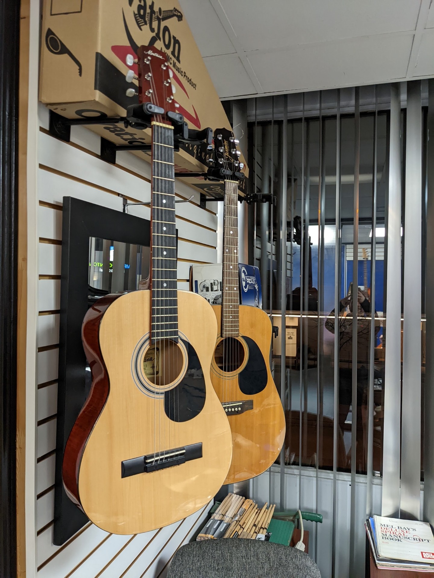 Acoustic guitars on the wall of our showroom